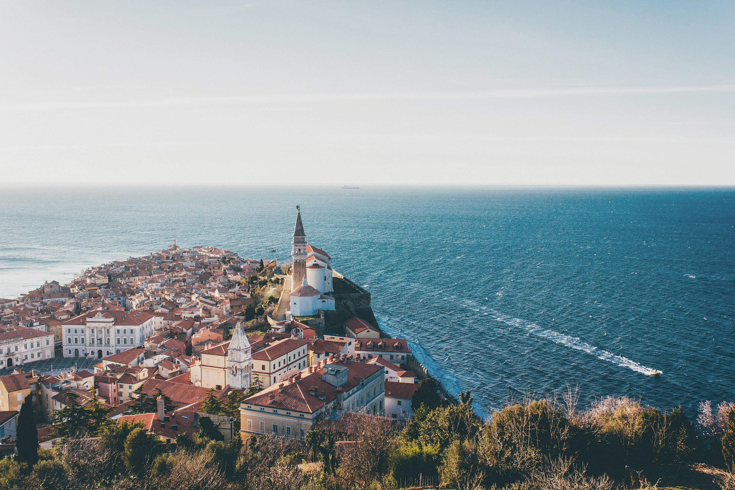 Piran and the Adriatic coast in warm evening light.