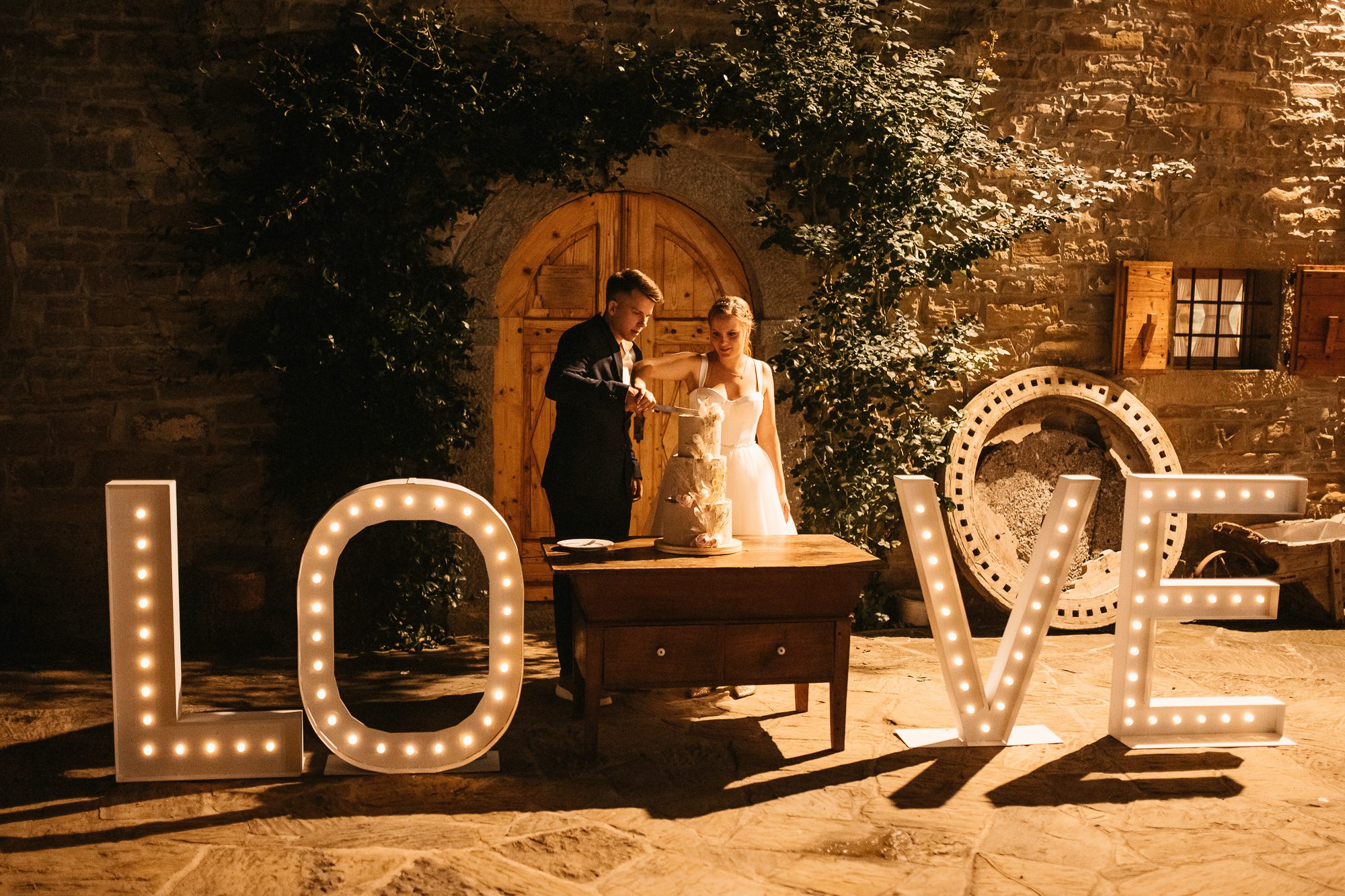 Tina and Tomaž cutting their wedding cake in Slovenia.